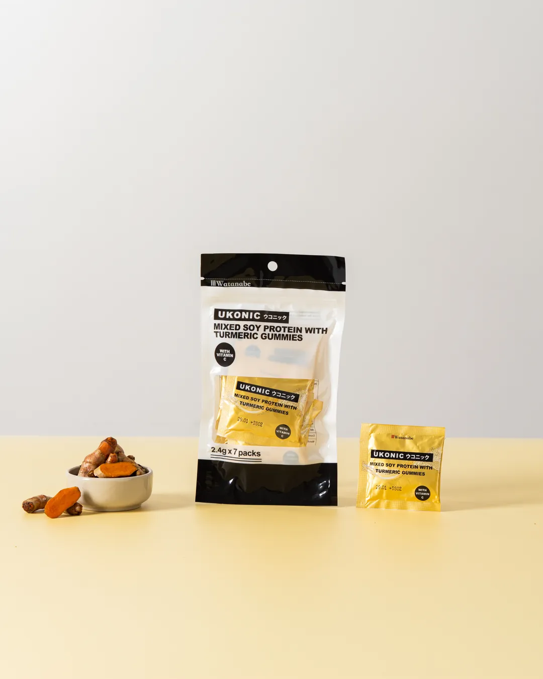 UKONIC Mixed Soy Protein with Turmeric Gummies pouch with fresh turmeric and a single-serve sachet