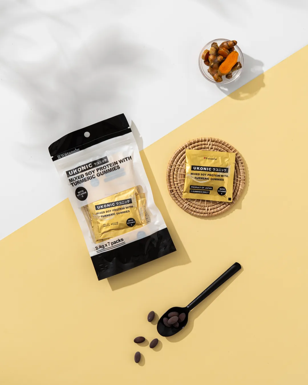UKONIC pouch and a single-serve sachet with fresh turmeric root and slices