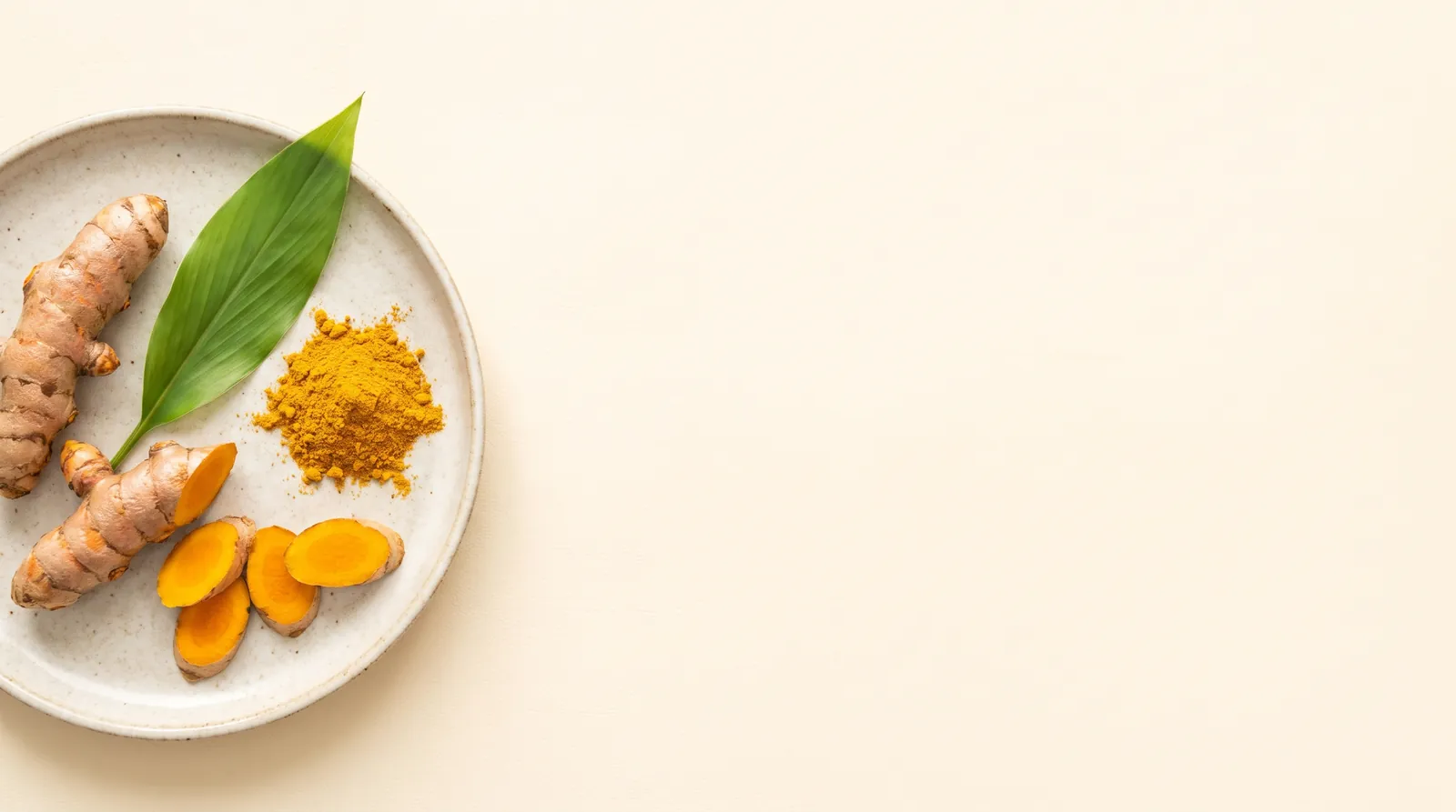 Fresh turmeric roots, slices and golden turmeric powder